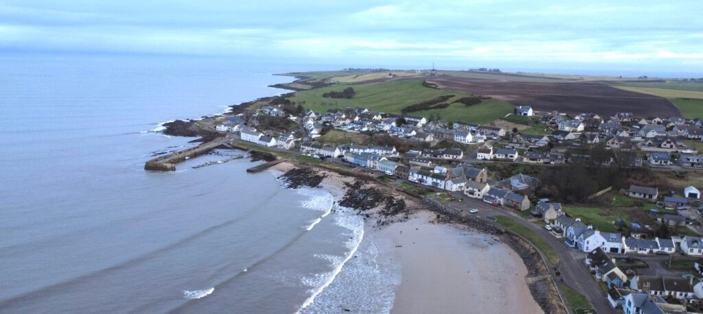 Drone shot of Portmahomack featuring Ina's Cottage.